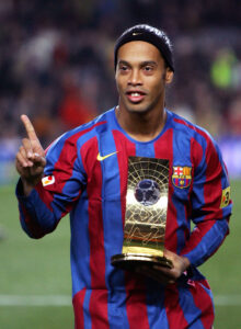 Barcelona's Ronaldinho of Brazil shows his FIFA world player trophy before their Spanish League soccer match against Celta at Nou Camp Stadium in Barcelona