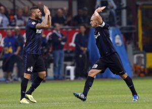Inter Milan's Cambiasso celebrates with his teammate Icardi after scoring against Fiorentina during their Italian Serie A soccer match at the San Siro stadium in Milan